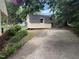 View of shed, concrete driveway, and established shrubbery on property at 609 Malone Ct, Burlington, NC 27215