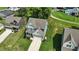 Aerial view of a home with blue siding featuring a manicured lawn and long driveway at 635 Black Angus Dr, Haw River, NC 27258