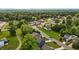 Aerial view of a residential area with lush greenery and diverse homes along winding roads at 635 Black Angus Dr, Haw River, NC 27258
