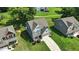 Inviting two-story home with lush lawn, stone accents, a gray roof, and an attached two-car garage at 635 Black Angus Dr, Haw River, NC 27258