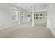 Spacious carpeted basement with natural light from multiple windows and a support column at 635 Black Angus Dr, Haw River, NC 27258