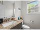 Bright bathroom with a granite countertop vanity, single sink, and natural light from the window at 635 Black Angus Dr, Haw River, NC 27258