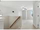 Upstairs landing that leads to a large carpeted area with a ceiling fan at 635 Black Angus Dr, Haw River, NC 27258