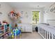 Cozy Bedroom with ample natural light, crib, and playful decor at 635 Black Angus Dr, Haw River, NC 27258