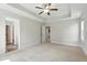 Spacious bedroom features a ceiling fan, tray ceiling, and multiple entry doors at 635 Black Angus Dr, Haw River, NC 27258