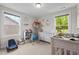 Bright Bedroom with two windows, a crib, and plush toys on display at 635 Black Angus Dr, Haw River, NC 27258
