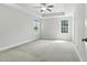 Spacious bedroom features a ceiling fan, carpet, and two bright windows at 635 Black Angus Dr, Haw River, NC 27258