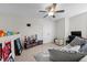 A large bonus room with carpet, featuring a gray couch, ceiling fan, and an open layout at 635 Black Angus Dr, Haw River, NC 27258