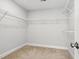 Spacious walk-in closet features carpeted flooring and built-in shelving at 635 Black Angus Dr, Haw River, NC 27258