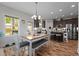 Bright dining area features wood floors, modern light fixture, and access to the kitchen at 635 Black Angus Dr, Haw River, NC 27258