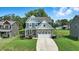 Charming two-story home with stone accents, a well-manicured lawn, and an attached two-car garage at 635 Black Angus Dr, Haw River, NC 27258