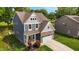 Aerial view of a charming two-story home with a stone facade and well-manicured lawn at 635 Black Angus Dr, Haw River, NC 27258