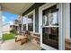 Inviting front porch featuring a cozy bench and stylish glass front door, adding charm at 635 Black Angus Dr, Haw River, NC 27258