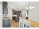 Modern kitchen with a center island, stainless appliances, granite counters, and a dining area at 635 Black Angus Dr, Haw River, NC 27258