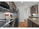 Modern kitchen boasting granite countertops, stainless steel appliances, and dark wood cabinets at 635 Black Angus Dr, Haw River, NC 27258