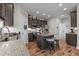 Well-equipped kitchen with an island, granite countertops, stainless steel appliances, and dark wood cabinets at 635 Black Angus Dr, Haw River, NC 27258