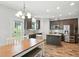 Modern kitchen with dark cabinets, stainless steel appliances, granite countertops, and a wood floor at 635 Black Angus Dr, Haw River, NC 27258