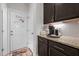 Mudroom entryway with a coffee bar featuring granite countertops and dark cabinetry at 635 Black Angus Dr, Haw River, NC 27258