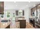 Contemporary kitchen with island, stainless appliances, granite counters, and a dining nook at 635 Black Angus Dr, Haw River, NC 27258