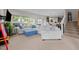 Spacious living room flowing into kitchen with neutral walls, carpet, large windows, and a comfortable sectional at 635 Black Angus Dr, Haw River, NC 27258