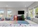 Bright living room provides plenty of natural light through large windows, neutral walls, and carpet at 635 Black Angus Dr, Haw River, NC 27258