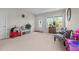 Bright and cheerful living room featuring neutral walls, carpet, and a large window for plenty of natural light at 635 Black Angus Dr, Haw River, NC 27258