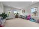 Bright living room offers neutral walls and carpet, large windows, and stylish, comfortable seating at 635 Black Angus Dr, Haw River, NC 27258