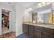 Spacious main bathroom with double sink vanity, granite counters, and wood-look flooring at 635 Black Angus Dr, Haw River, NC 27258