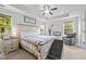 Inviting main bedroom featuring a tray ceiling, ceiling fan, and multiple windows for natural light at 635 Black Angus Dr, Haw River, NC 27258