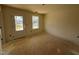 Bedroom with a door to backyard access and a window, natural light, and neutral paint colors at 682 Old Station Pointe, Angier, NC 27501