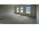 Bright bedroom featuring three windows offering ample natural light and tray ceiling in new construction home at 682 Old Station Pointe, Angier, NC 27501