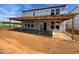 New home with a large covered patio and visible framing at 682 Old Station Pointe, Angier, NC 27501