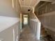 Unfinished hallway with visible staircase and natural light streaming from the end windows at 682 Old Station Pointe, Angier, NC 27501
