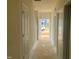 Hallway featuring clean lines, neutral paint, and an entry view showcasing the natural light and front yard at 682 Old Station Pointe, Angier, NC 27501