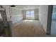 Sunlit living room with windows showcasing scenic neighborhood views, ready for design at 682 Old Station Pointe, Angier, NC 27501