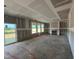 Spacious living room with three windows and a fireplace, awaiting final touches at 682 Old Station Pointe, Angier, NC 27501