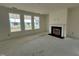 Living room featuring a fireplace, large windows, and neutral paint colors at 682 Old Station Pointe, Angier, NC 27501