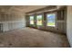 Open living room with multiple windows showcasing scenic neighborhood views, ready for design at 682 Old Station Pointe, Angier, NC 27501