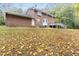 Lawn view from an expansive backyard with a brick home, bay window, and wooden deck at 6824 Branton Dr, Cary, NC 27519
