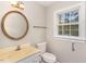 Bathroom includes a mirror, sink, toilet, and window at 6824 Branton Dr, Cary, NC 27519