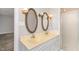 Double vanity bathroom with two oval mirrors and a glass-enclosed shower at 6824 Branton Dr, Cary, NC 27519