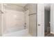 Bathroom featuring a tiled shower and tub, a white door, and a brass towel rack at 6824 Branton Dr, Cary, NC 27519