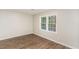Bedroom featuring hardwood floors, a window, and neutral paint at 6824 Branton Dr, Cary, NC 27519