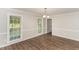 Bright dining room with hardwood floors, chandelier, and a window at 6824 Branton Dr, Cary, NC 27519