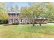 Traditional brick home with well-manicured lawn and mature trees at 6824 Branton Dr, Cary, NC 27519