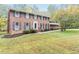 Traditional brick home with shutters, a manicured lawn, and mature trees at 6824 Branton Dr, Cary, NC 27519