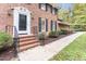 Charming brick home with a classic front entrance and black railing at 6824 Branton Dr, Cary, NC 27519