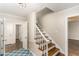 Hallway with hardwood floors, open staircase, and blue rug at 6824 Branton Dr, Cary, NC 27519