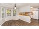 Eat-in kitchen with vintage style cabinets, new wood look flooring, and window views at 6824 Branton Dr, Cary, NC 27519