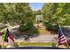 Aerial view of home featuring circular drive, beautiful landscaping, and mature trees at 8308 Society Pl, Raleigh, NC 27615
